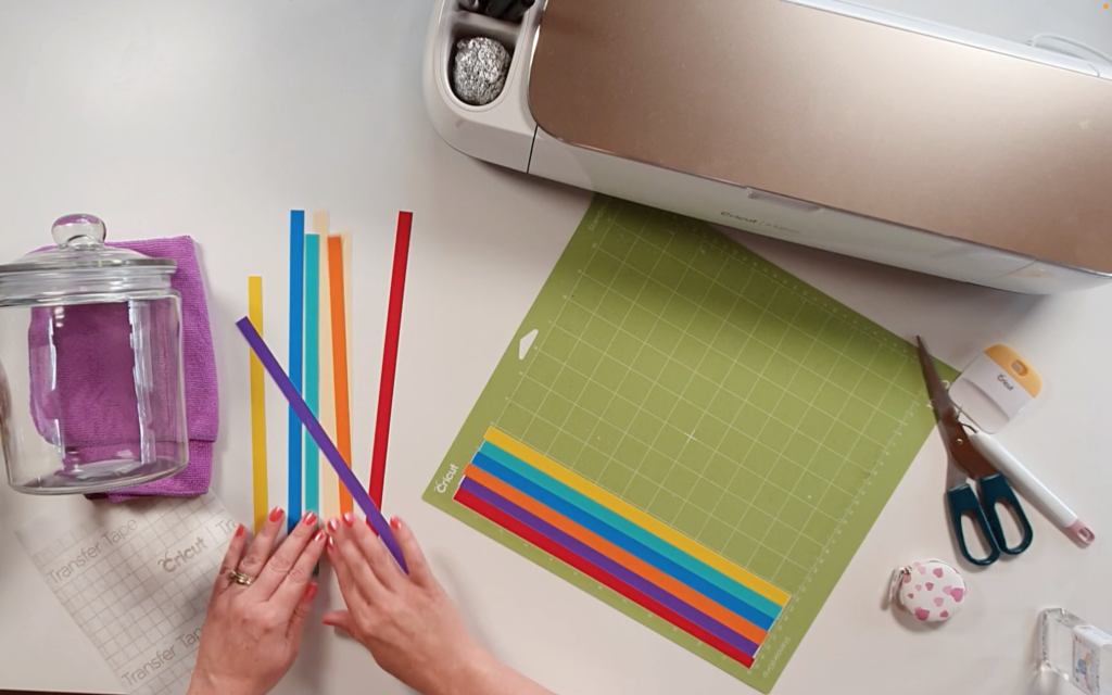 Placing the strips of vinyl onto the cutting mat in random colour formation