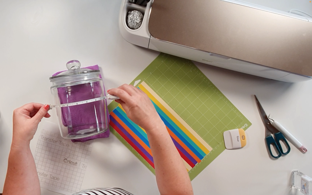 Measuring the front of the jar with a tape measure