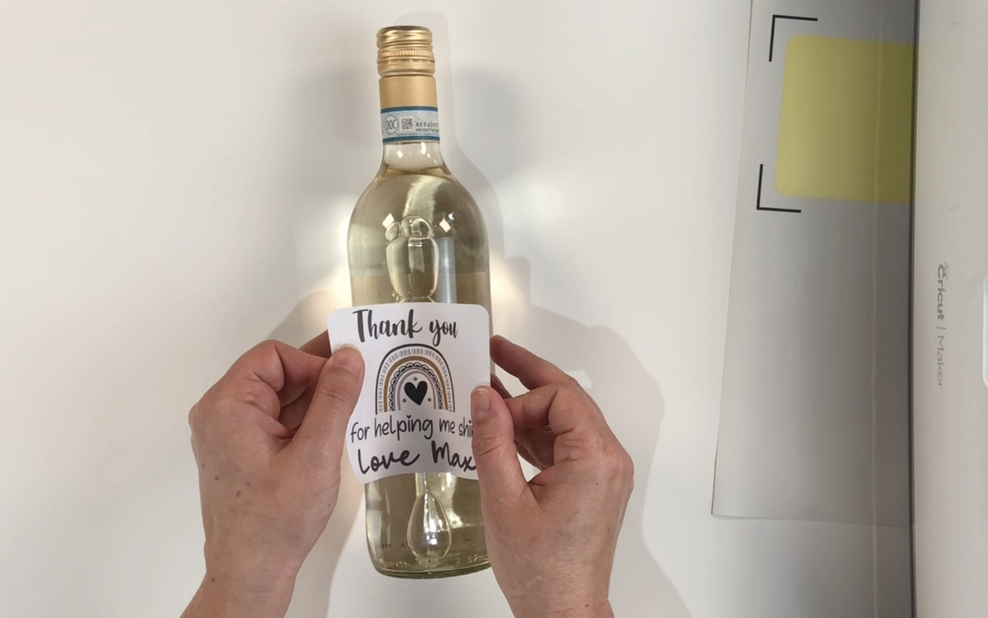 Placing the wine label onto the front of the wine bottle