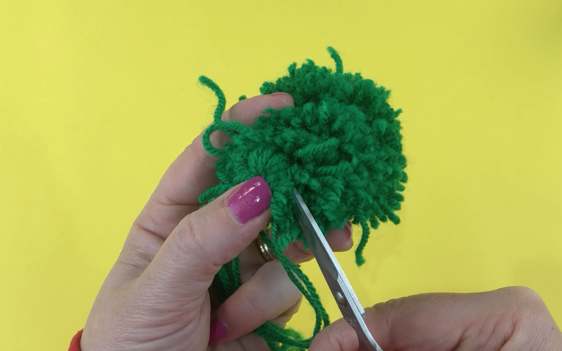 Cutting through the hoops of the tied wool using small sharp scissors 