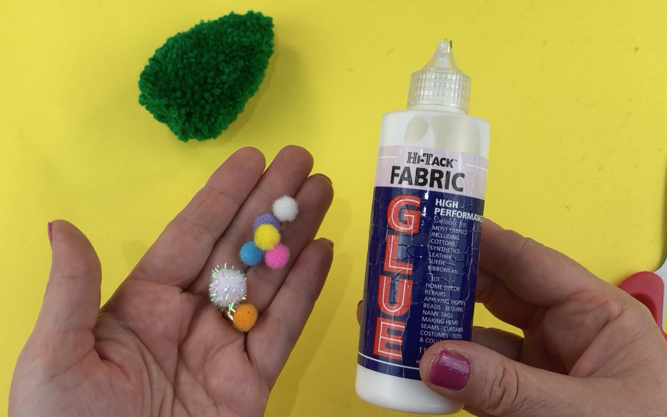 Fabric glue and small colourful pompoms