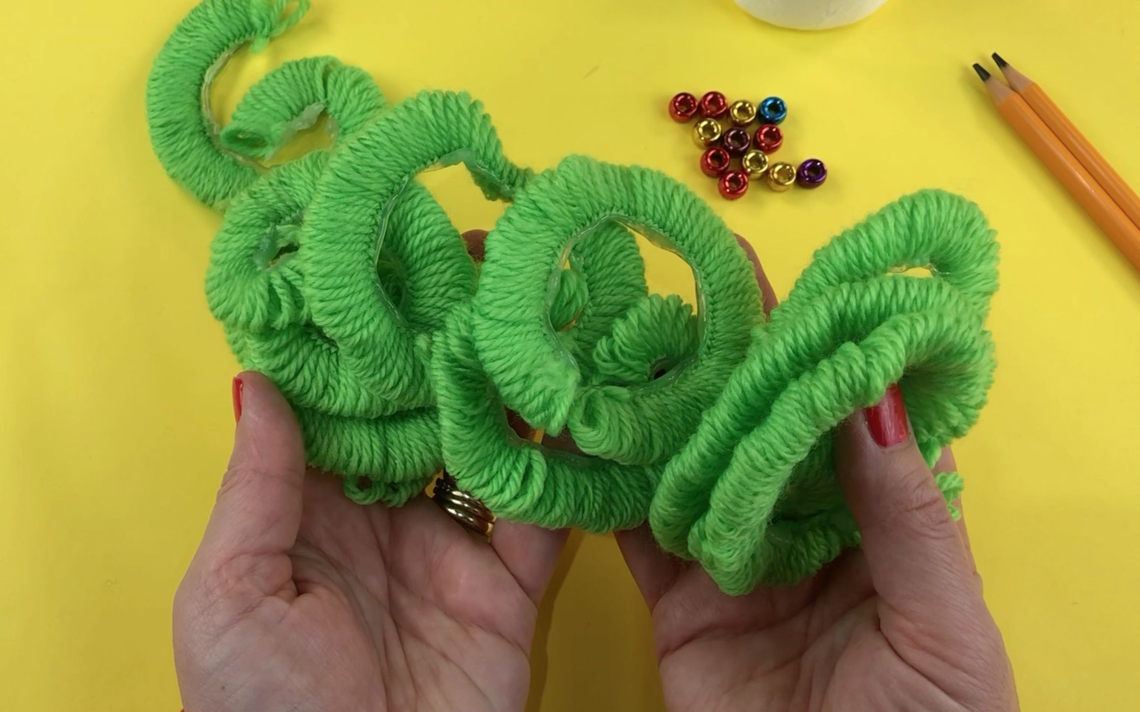 Multiple pieces of looped wool ready to apply to the cone.