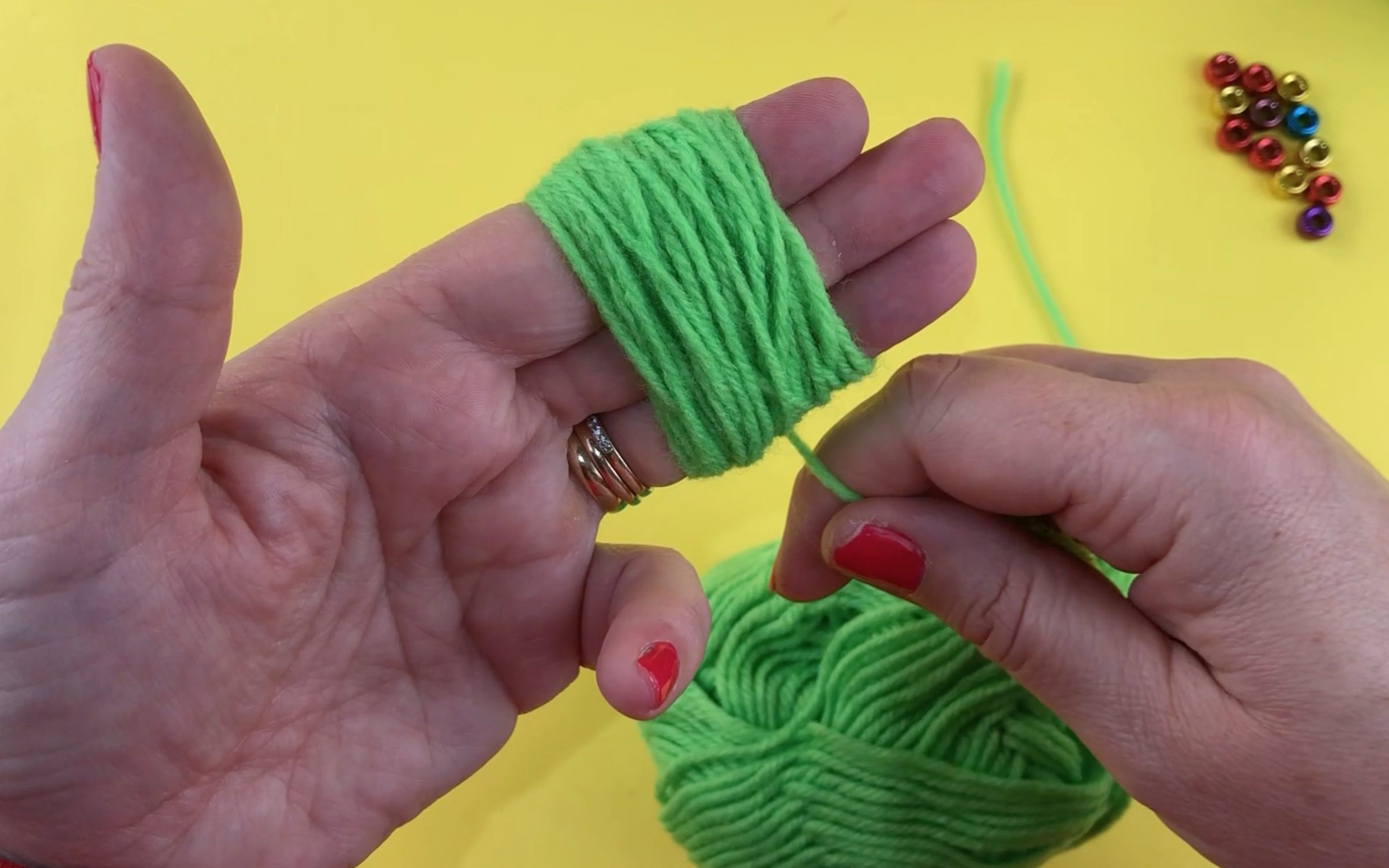 Wrapping wool around 3 fingers. This is to make the pompom