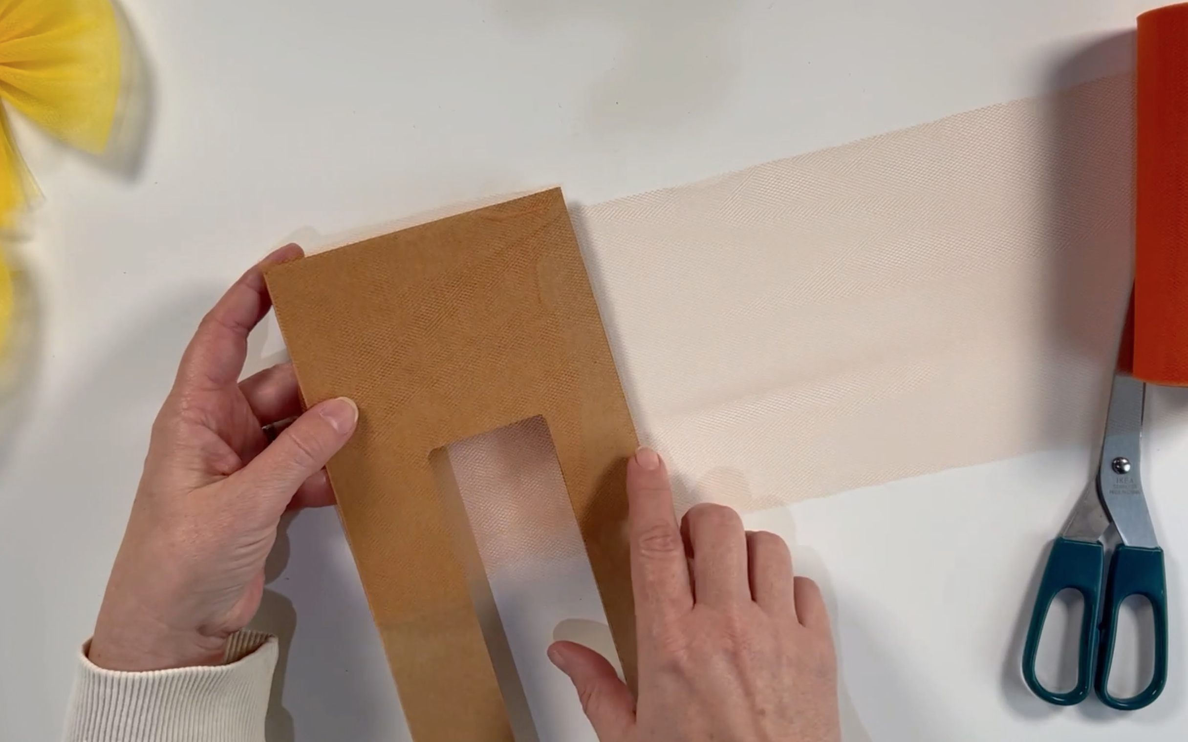 Wrap the tulle around the cardboard template.