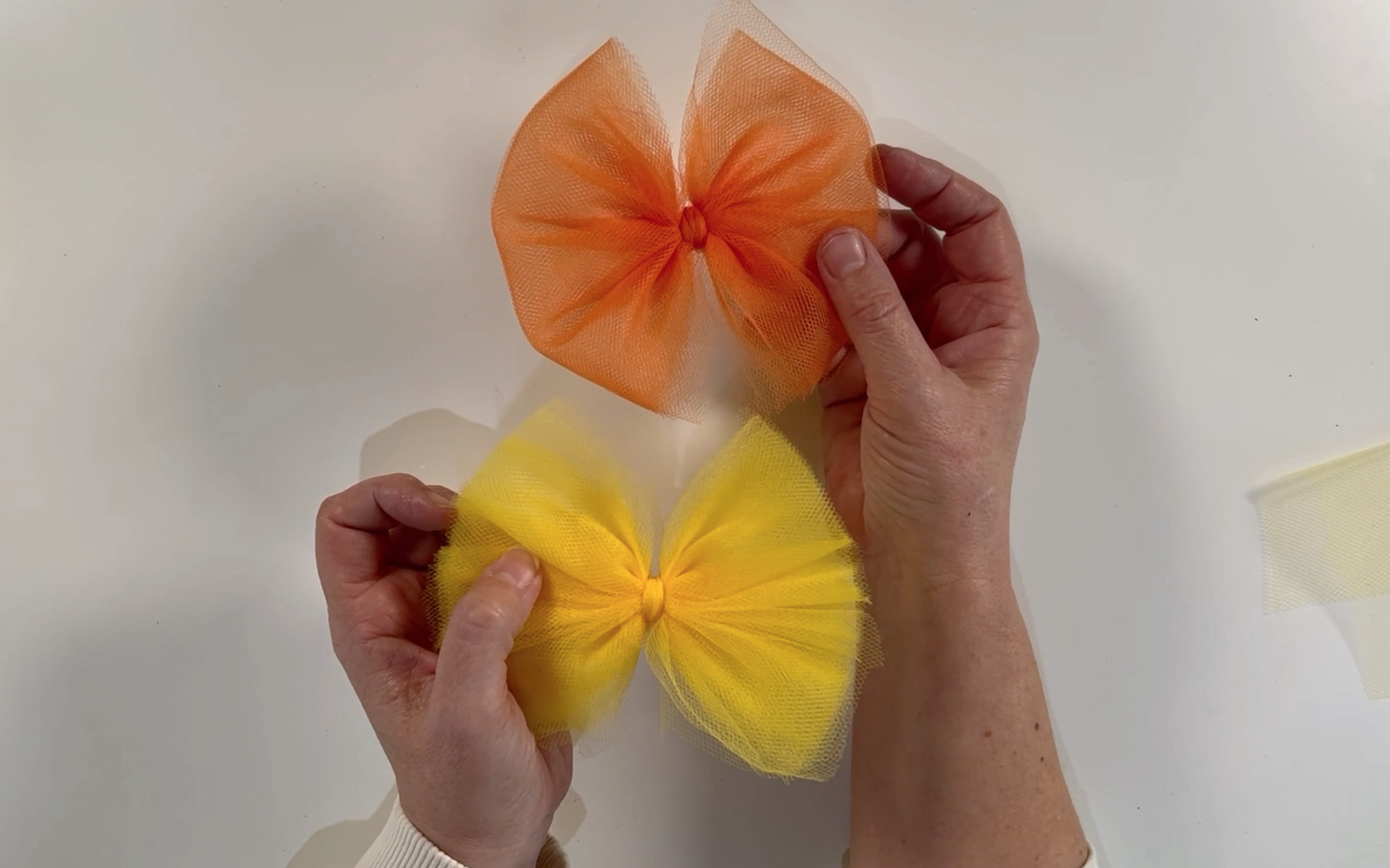 An orange and yellow tulle bow. 