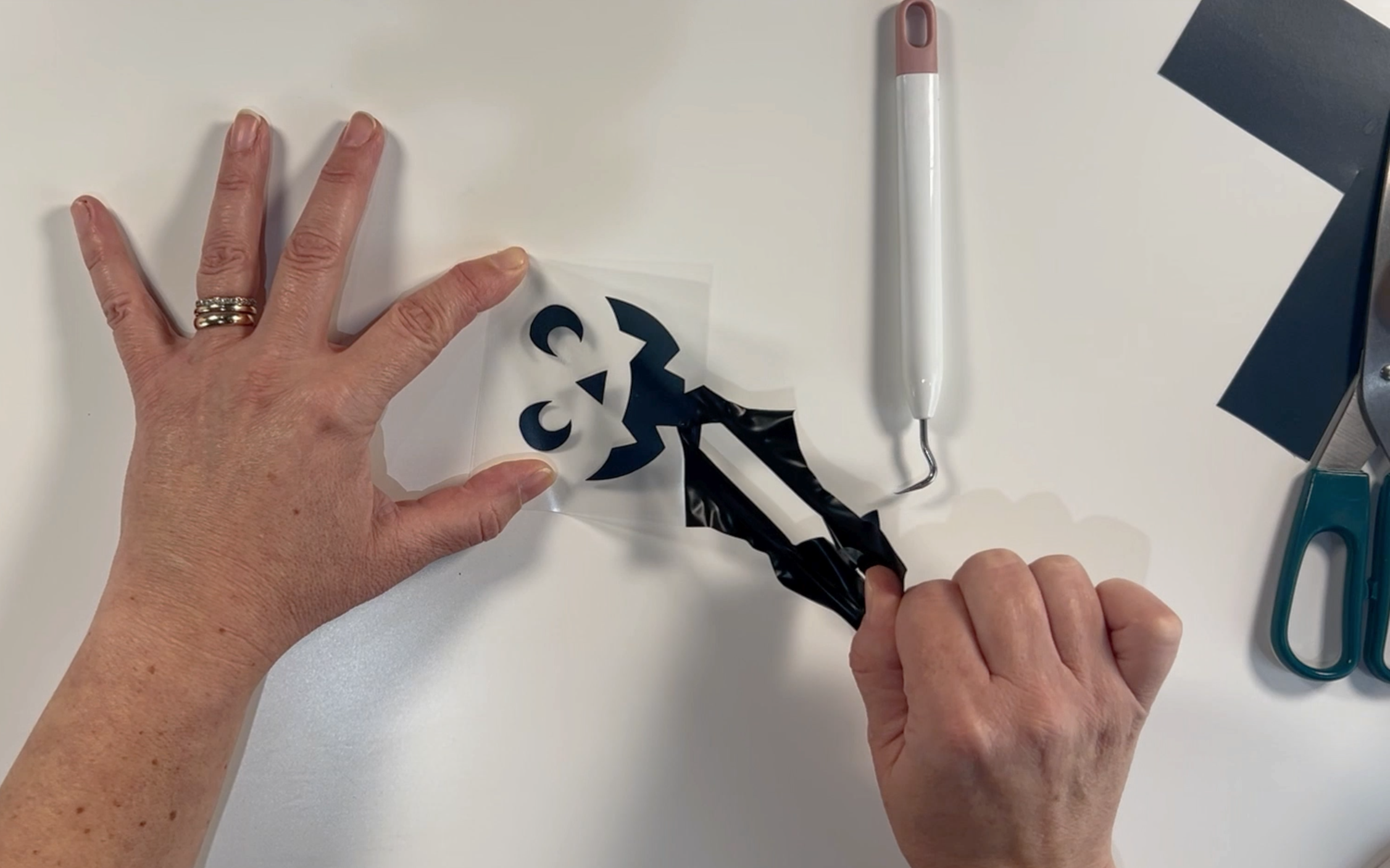 Removing the excess vinyl from the design after weeding it