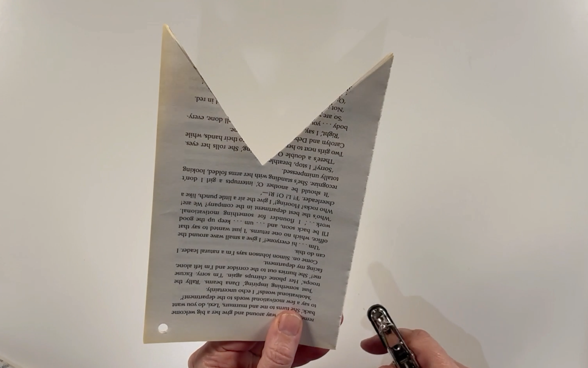 Punching a hole in the top corners of the flags using the single hole punch