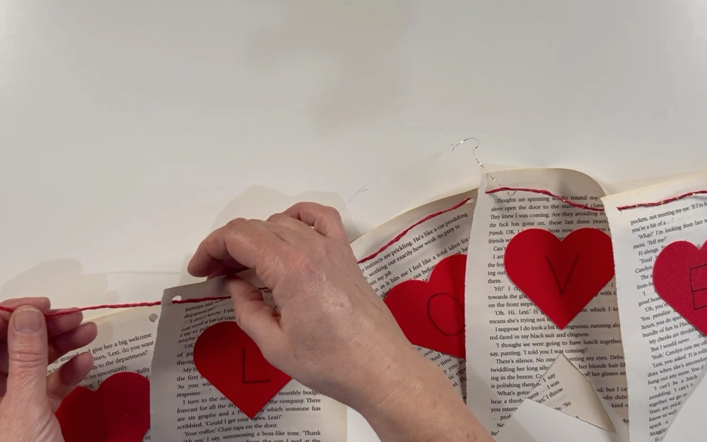 Threading the twine through the holes in the banner flags.I hope you 