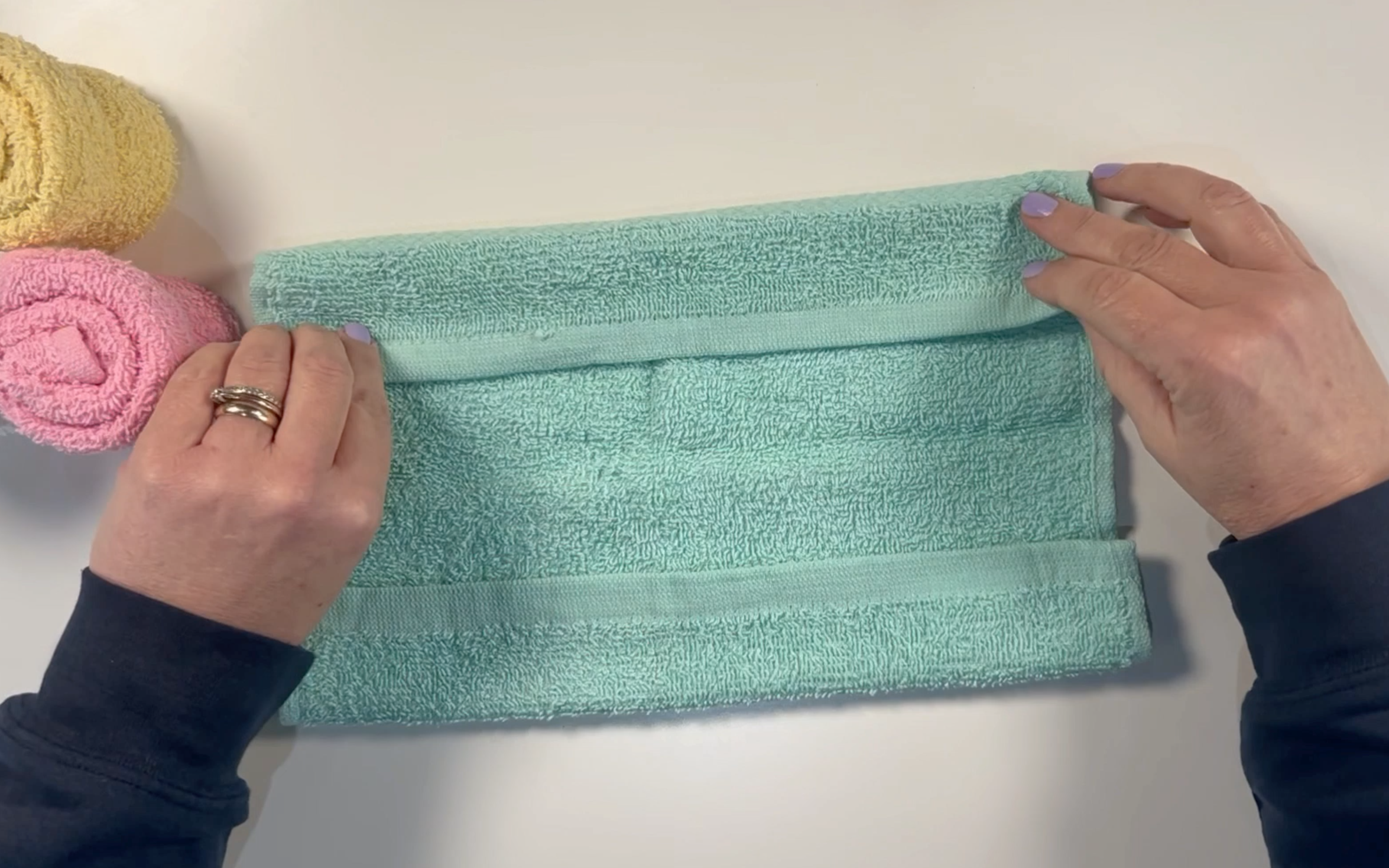 Folding the green washcloth over slightly at both sides