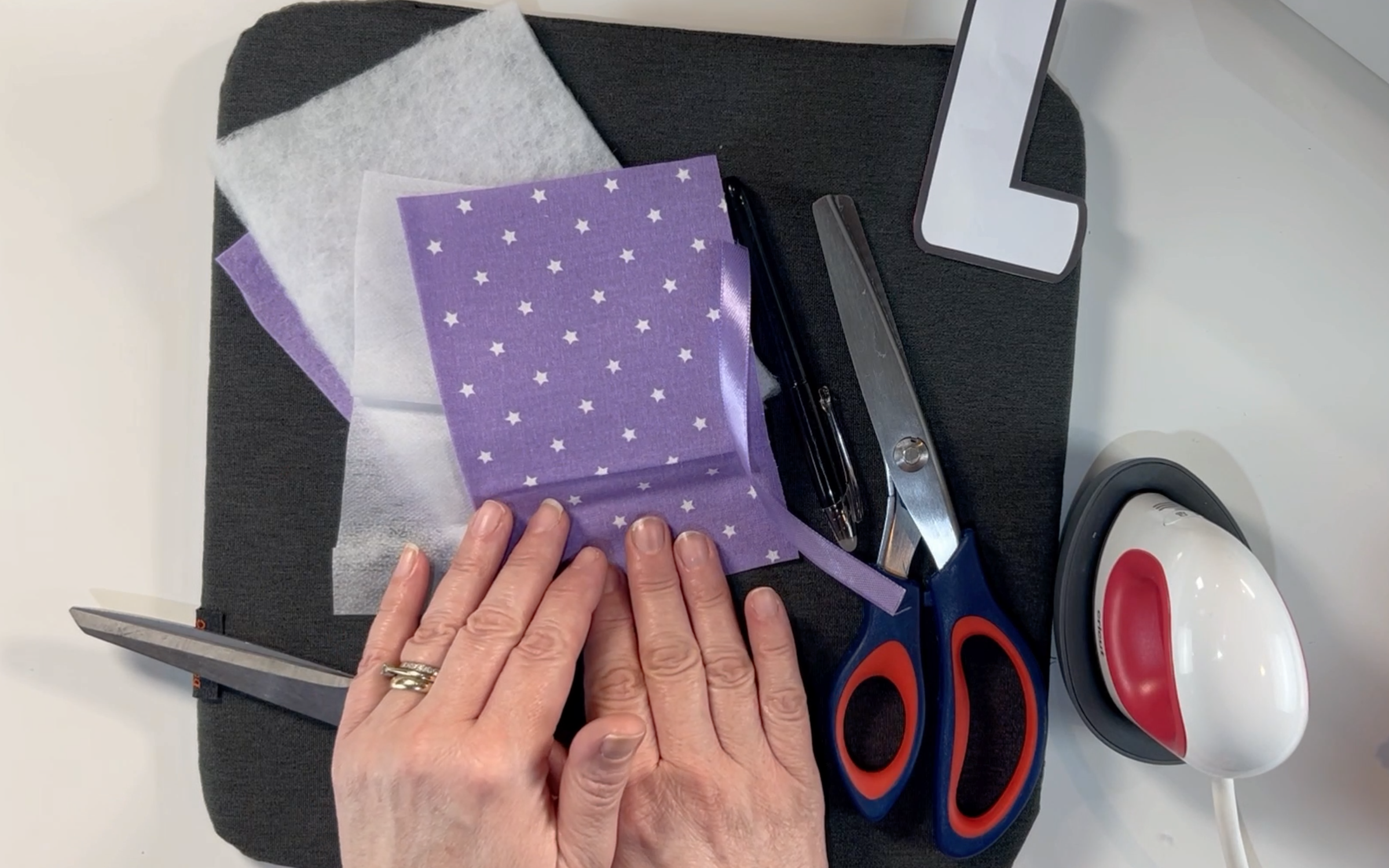 supplies i used to make my padded letters: heat mat, mini heat press, material scissors, pinking shears, material pen, fat quarter, wadding, fusible interfacing.