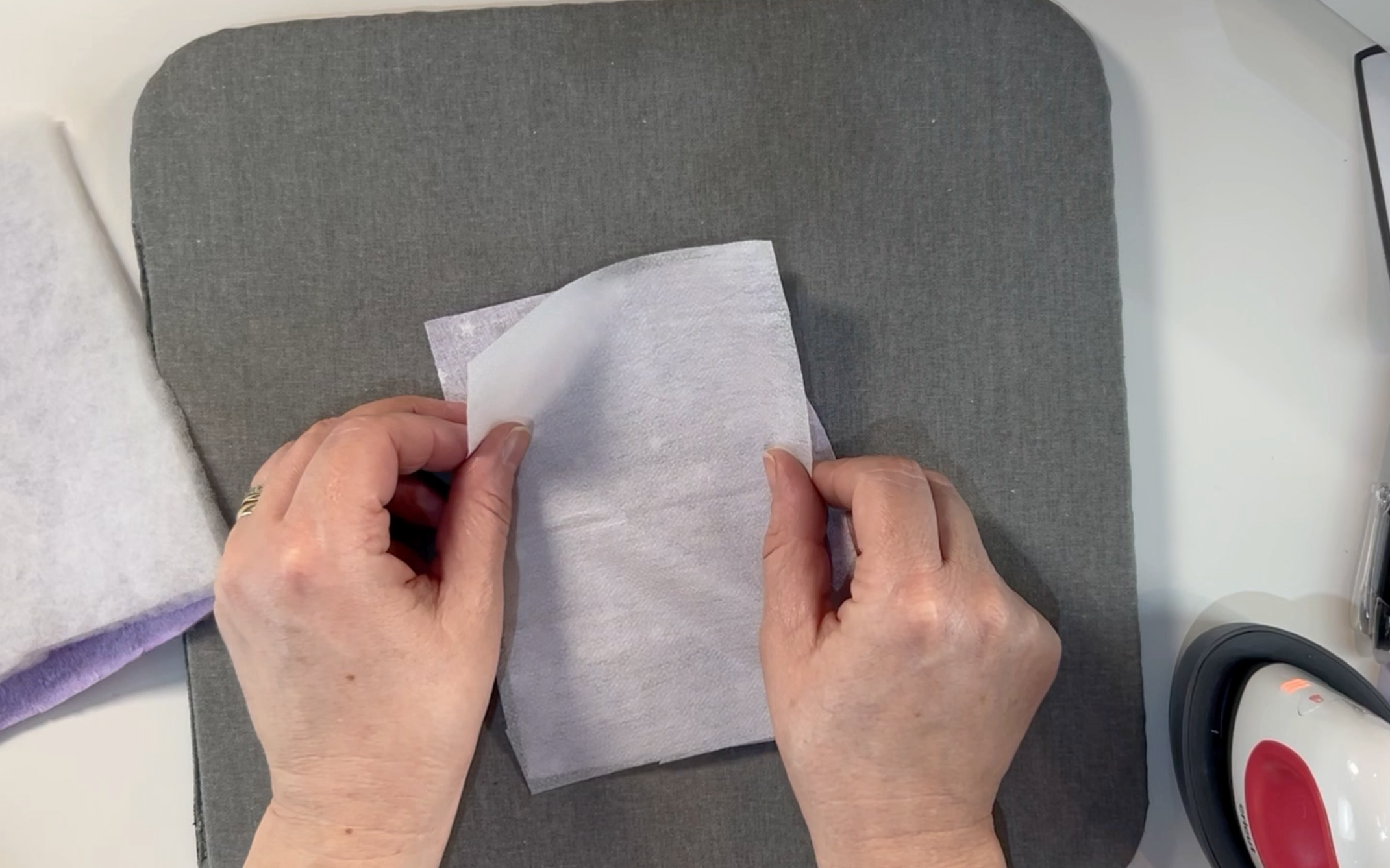 Laying the fusible interfacing onto the material.