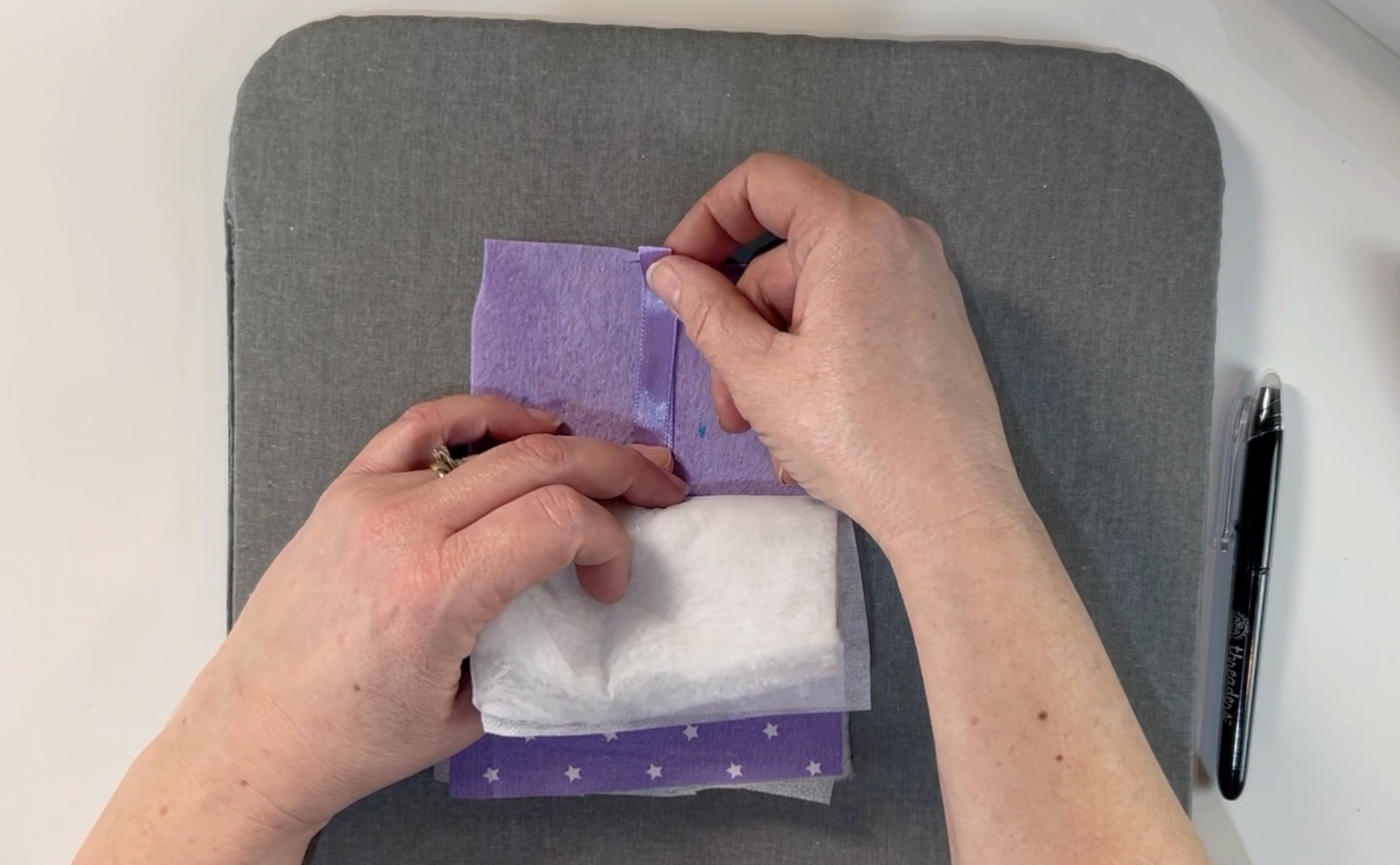 adding some ribbon to the top of the letter and placing it inbetween the layers