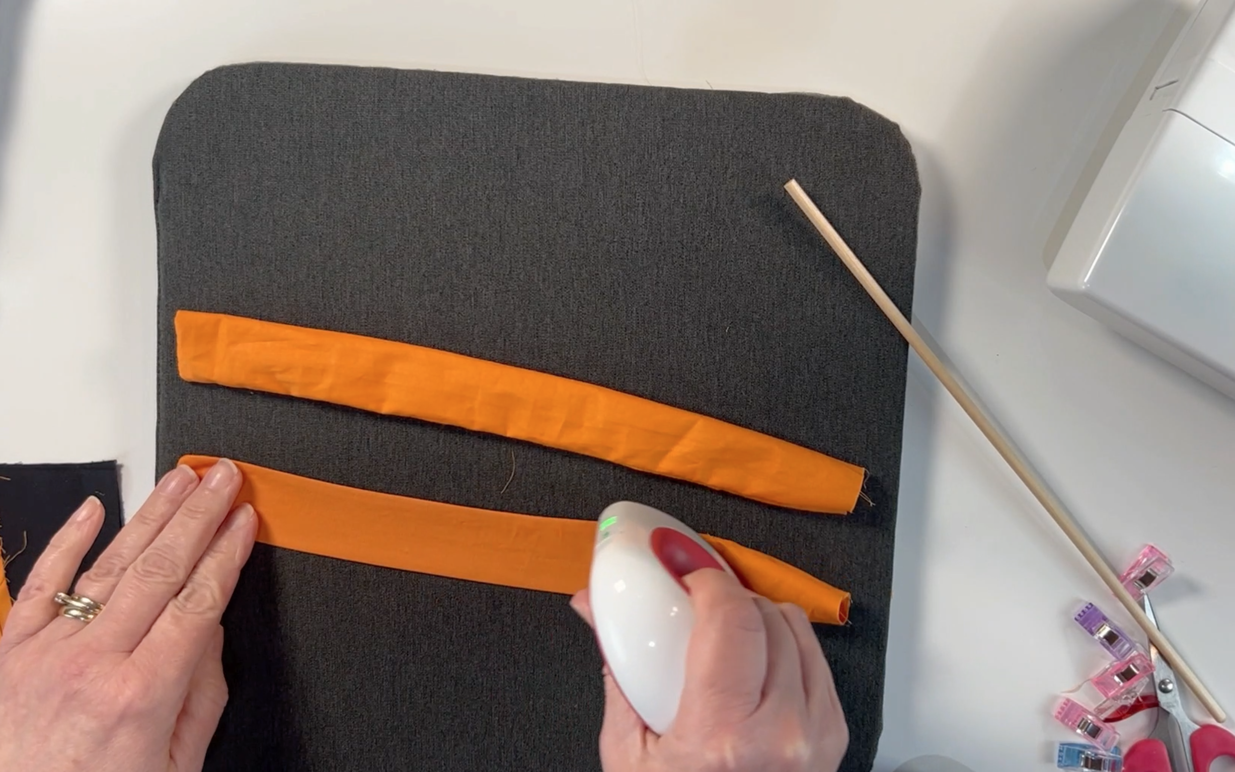 Pressing the orange straps using the min heat press