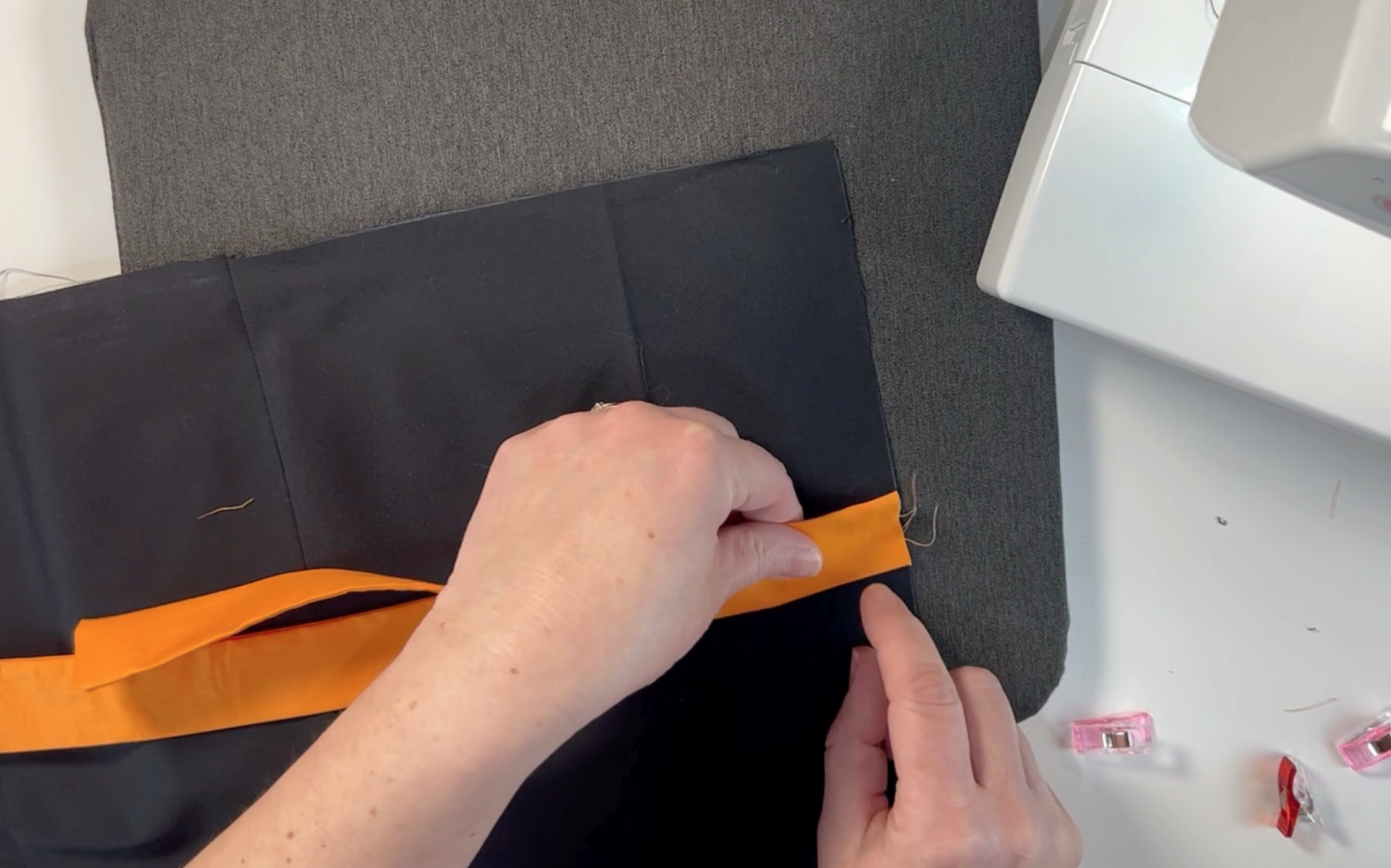 lining up the centre point of the black material with centre point of the orange material