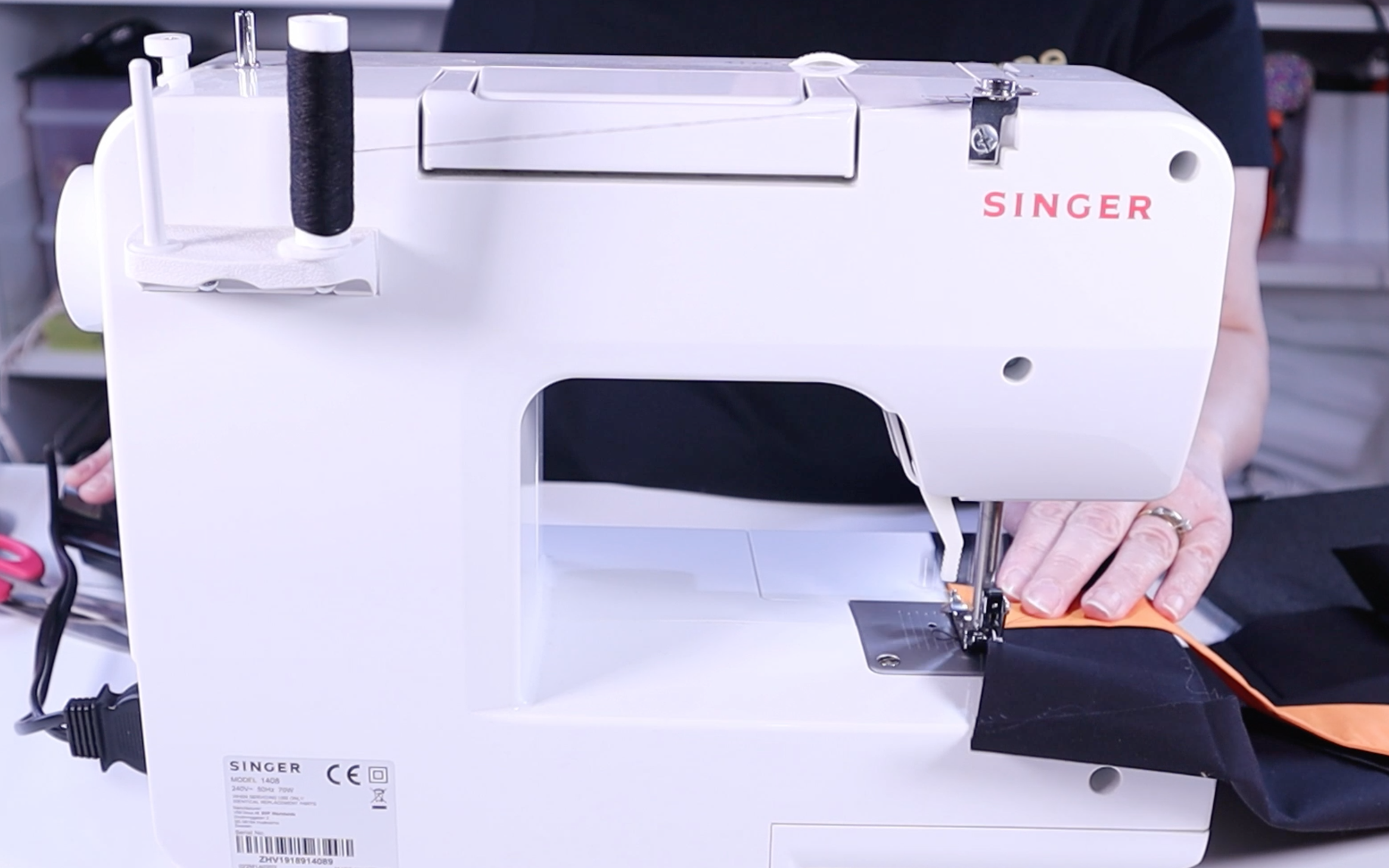 sewing the straps in place using a singer promise sewing machine