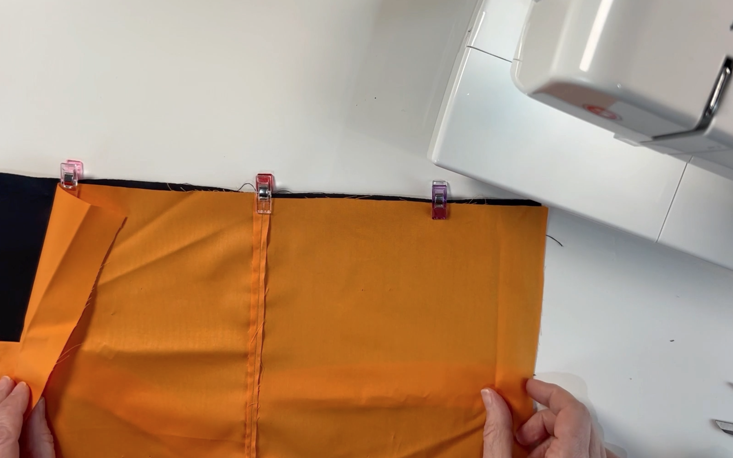 Clipping the black and orange material together using the material clips