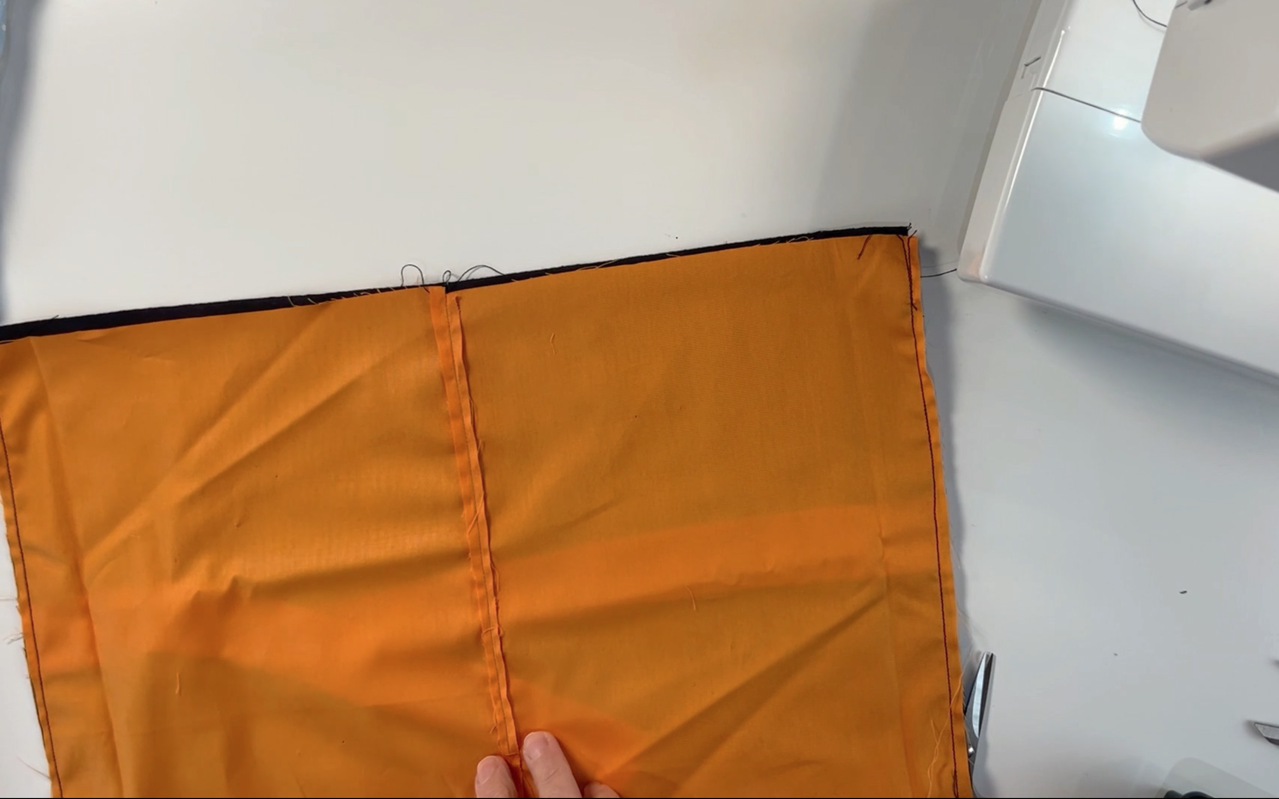 the black and orange material sewn together down the shortest edges
