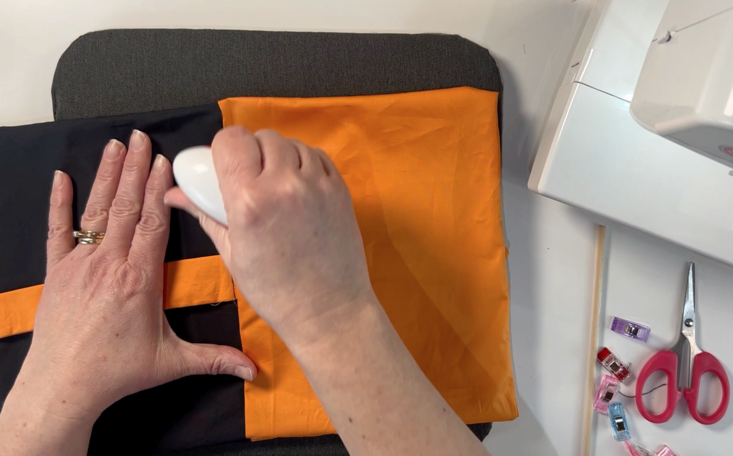 pressing the sewn material that has been turned the right way around using the mini heat press