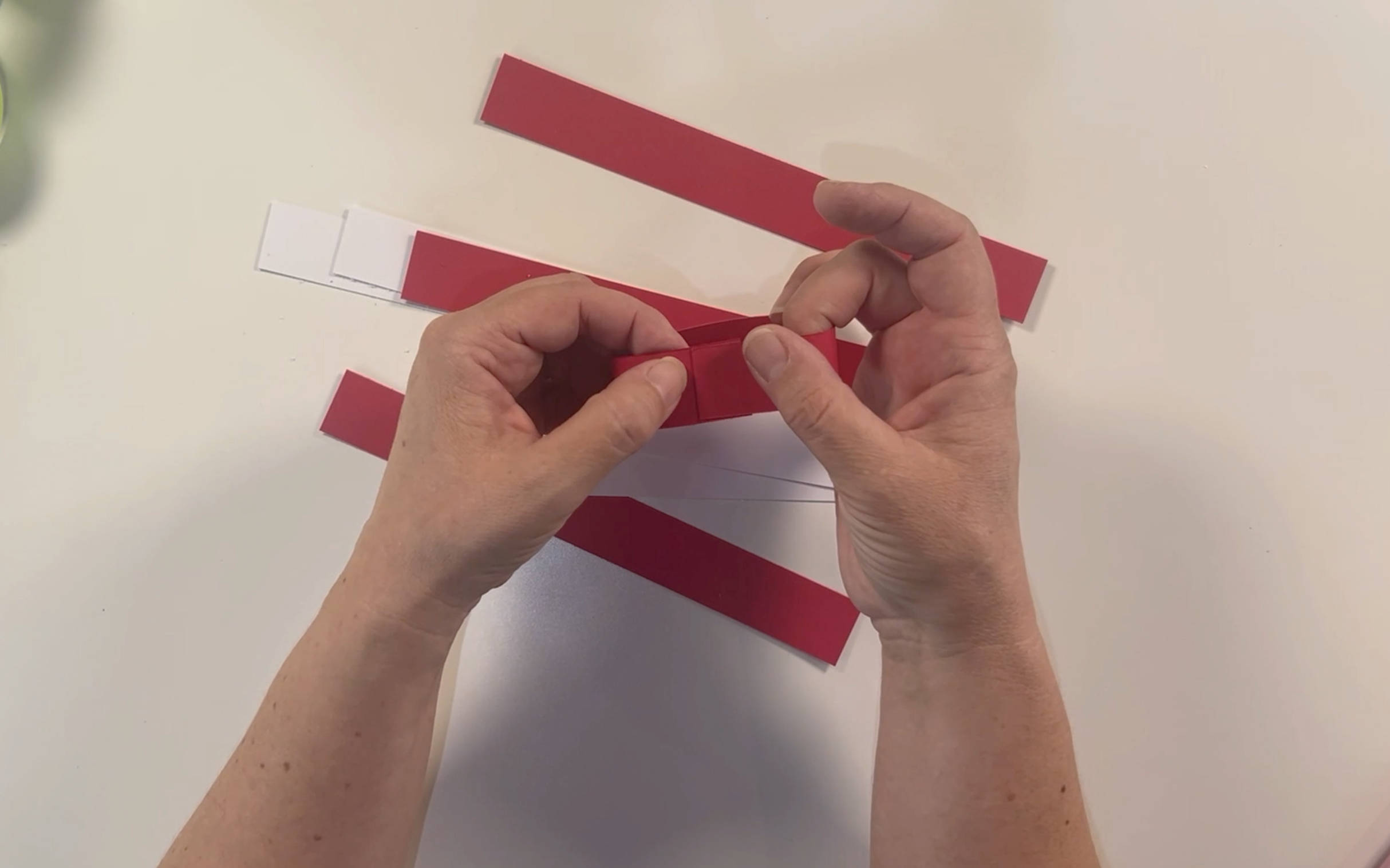 folding the red card so that the two end pieces overlap.