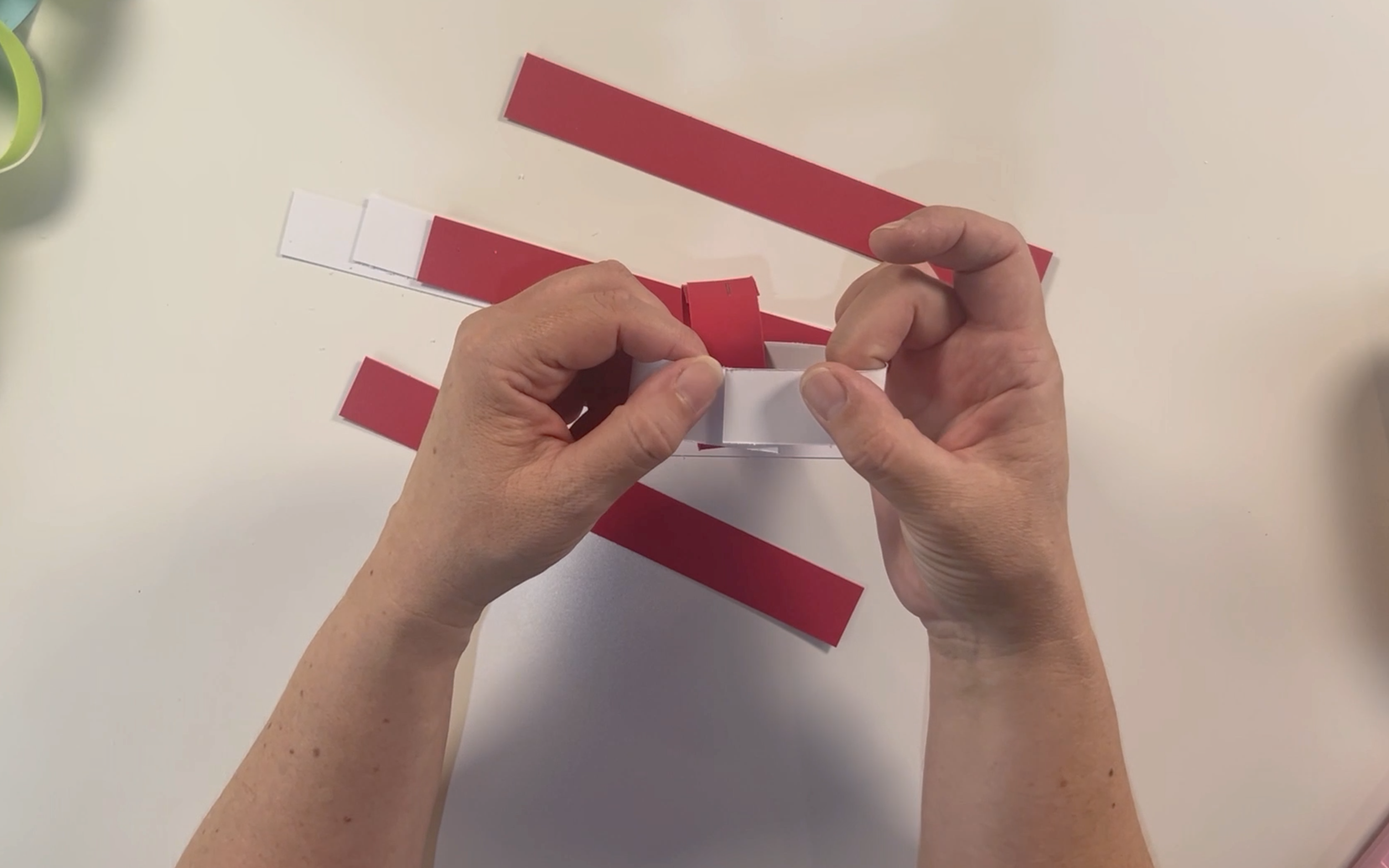 folding the white card so that the two end pieces overlap.