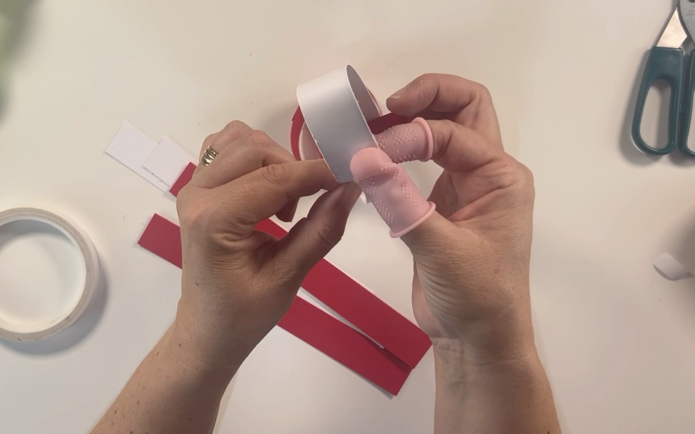 Using hot glue to secure the ends of the card together. Also using the finger protectors