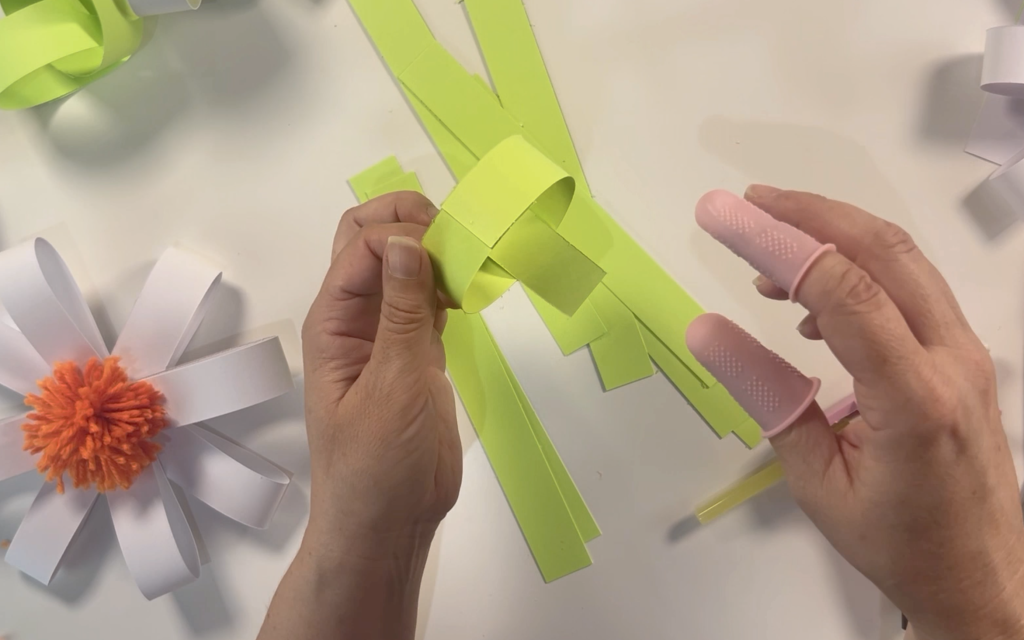 Making hoops with green card to form the paper chain