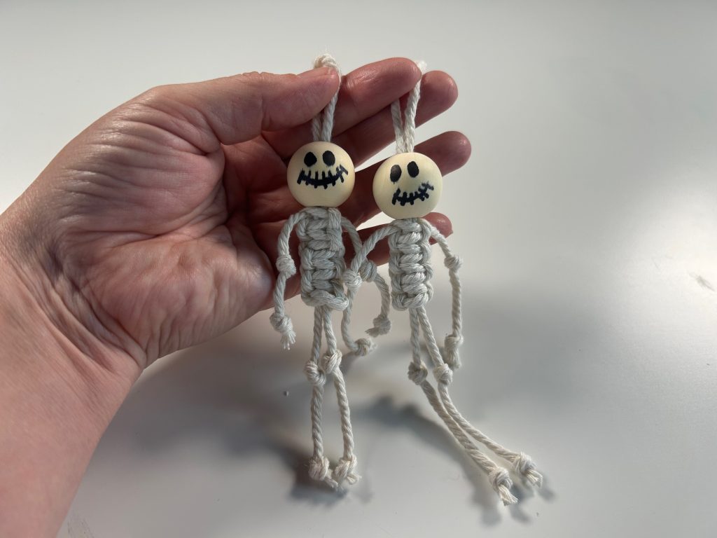 2 macrame skeletons with beads for their heads