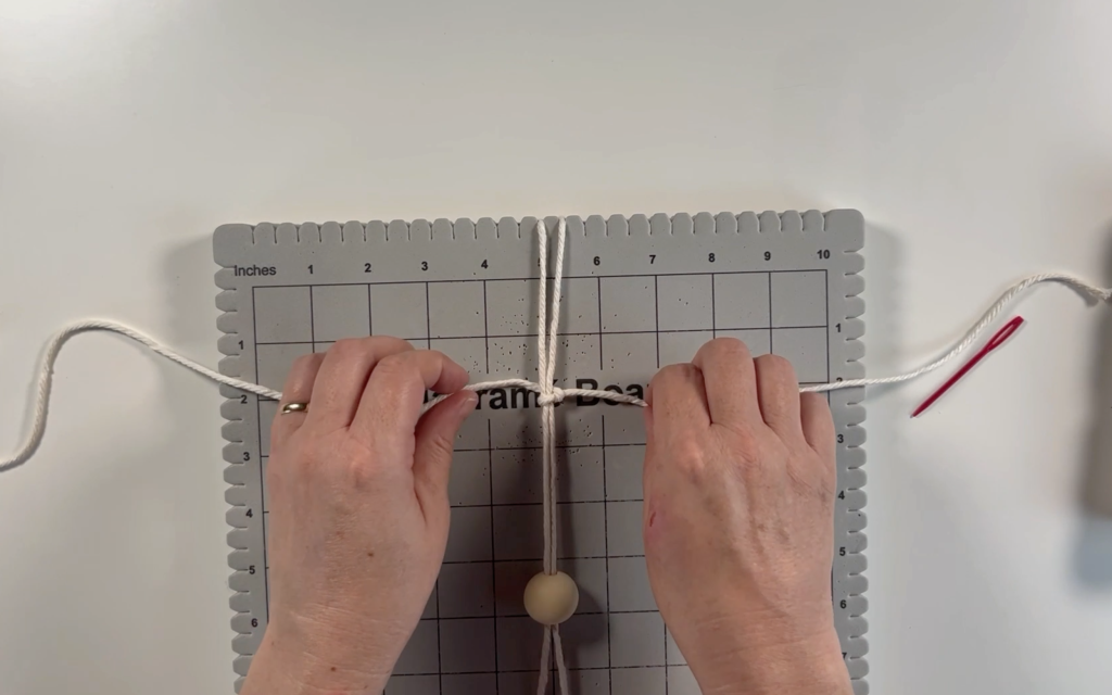 Making a square knot with the cord