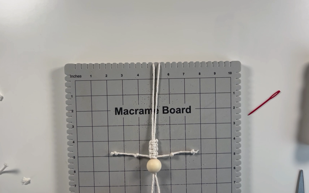 2 knots tied in each of the strands of macrame cord to make the skeleton arms