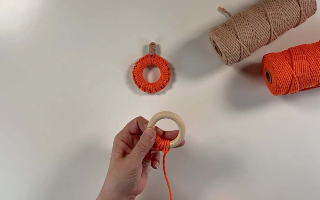 Making more larkshead knots through the wooden ring