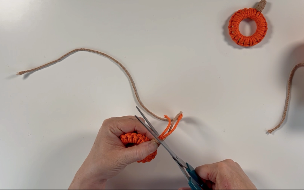Trimming off the long strands of macrame cord that i no longer need