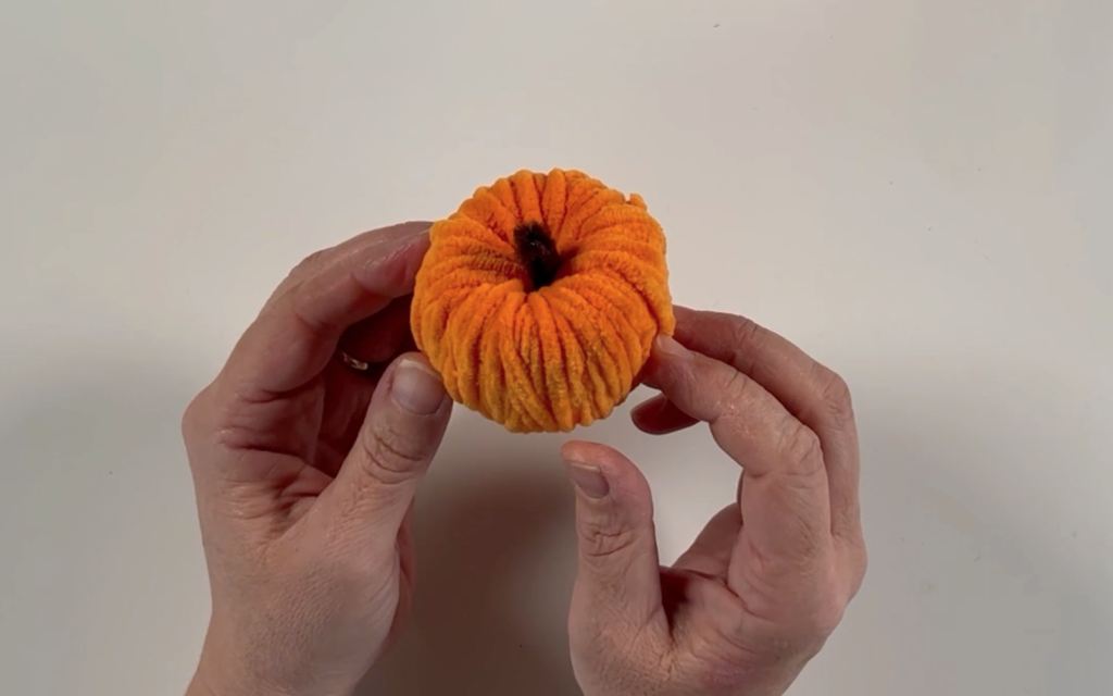 The yarn wrapped pumpkin with the twisted brown pipe cleaner pushed in the top to look like a stork.