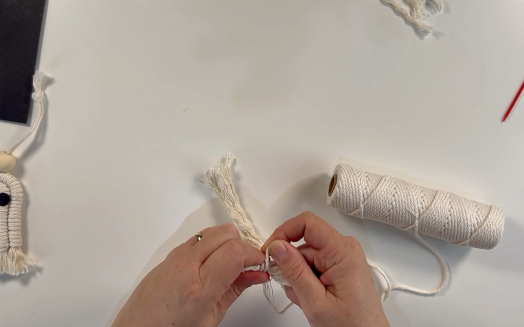Wrapping the 3mm macrame cord around the separated strands of cord